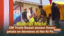 Kumbh Mela: CM Tirath Rawat shower flower petals on devotees at Har Ki Pauri