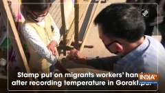 Stamp put on migrants workers' hands after recording temperature in Gorakhpur