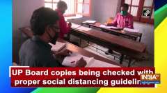 UP Board copies being checked with proper social distancing guidelines