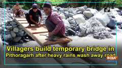 Villagers build temporary bridge in Pithoragarh after heavy rains wash away road