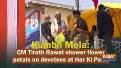 Kumbh Mela: CM Tirath Rawat shower flower petals on devotees at Har Ki Pauri