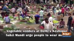 Vegetable vendors at Delhi's Keshopur Sabzi Mandi urge people to wear masks